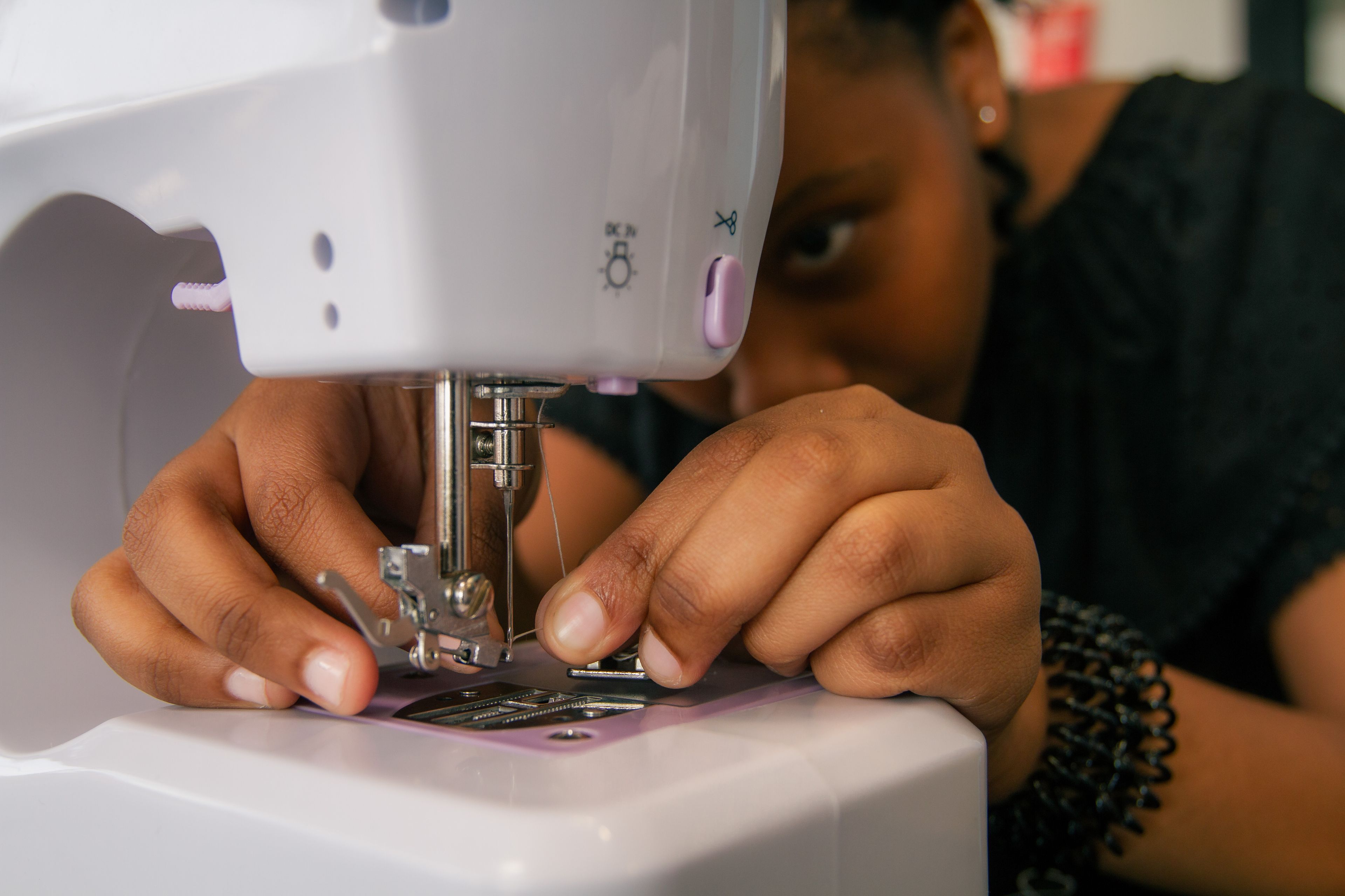 Enactus Wits students working on the Drip Tailors social enterprise, upcycling clothing and training youth in tailoring skills.