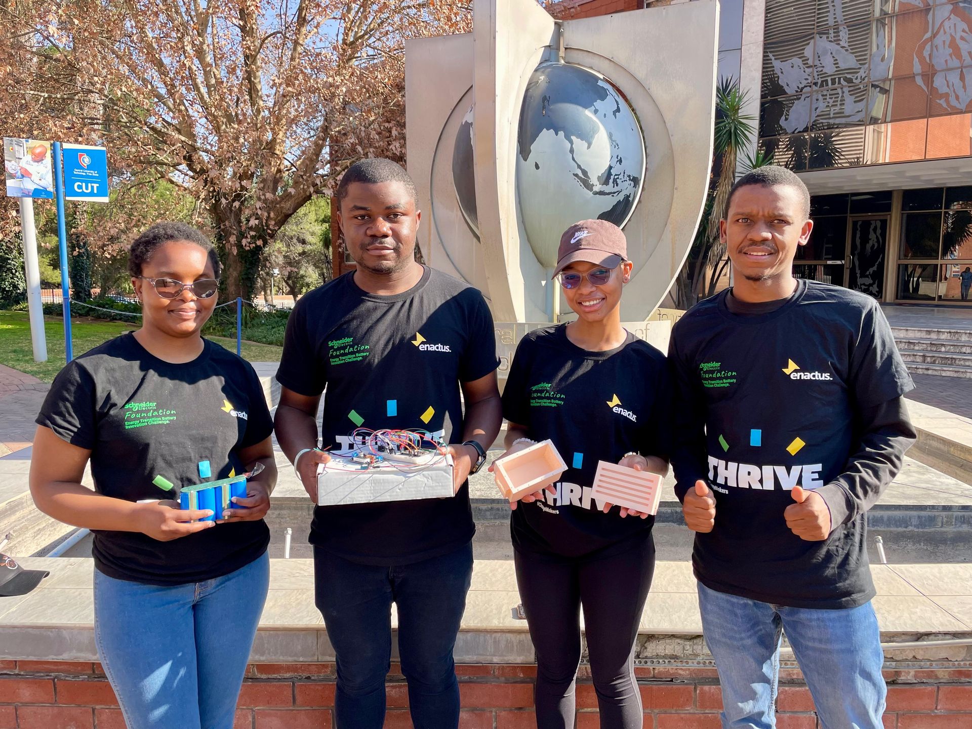 Enactus team members display their team's innovative battery pack and BMS, a project entry for the Schneider Electric Foundation Battery Innovation Challenge.