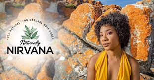 A woman , Nicole Louw with curly hair in a yellow top is beside orange rocks, exuding a serene vibe. "Naturally Nirvana" logo with green leaves is on the left.