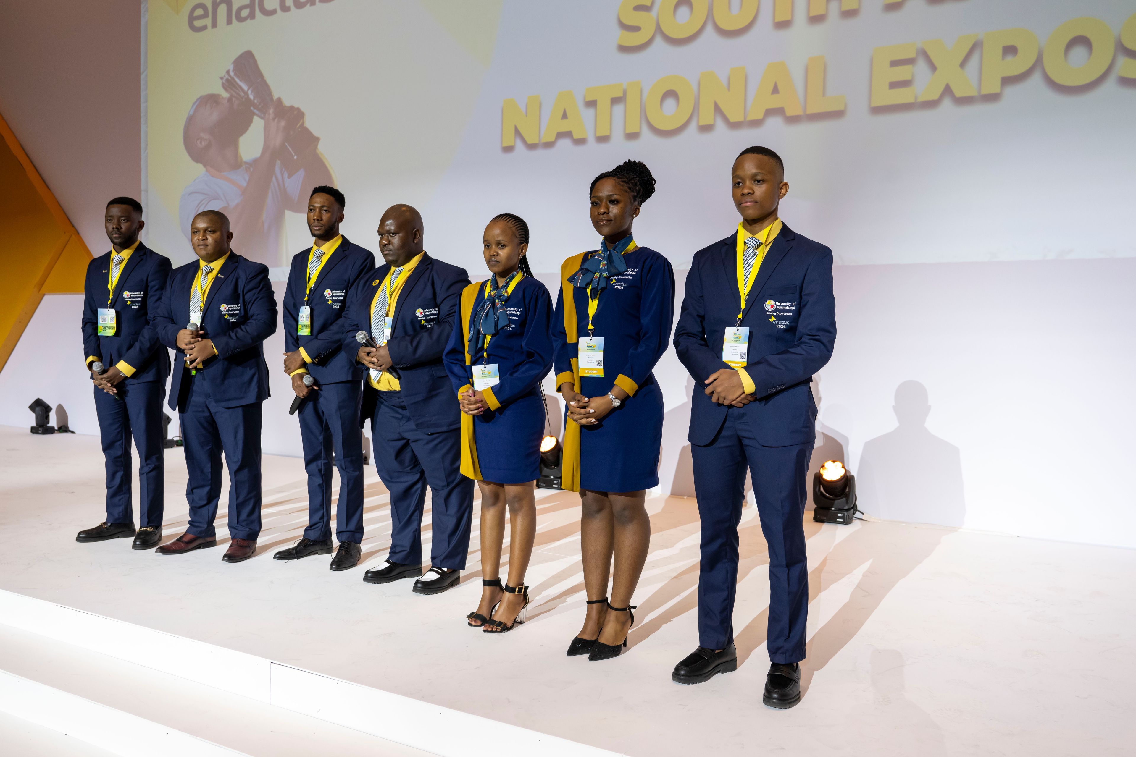 Enactus UMP students presenting their project on stage