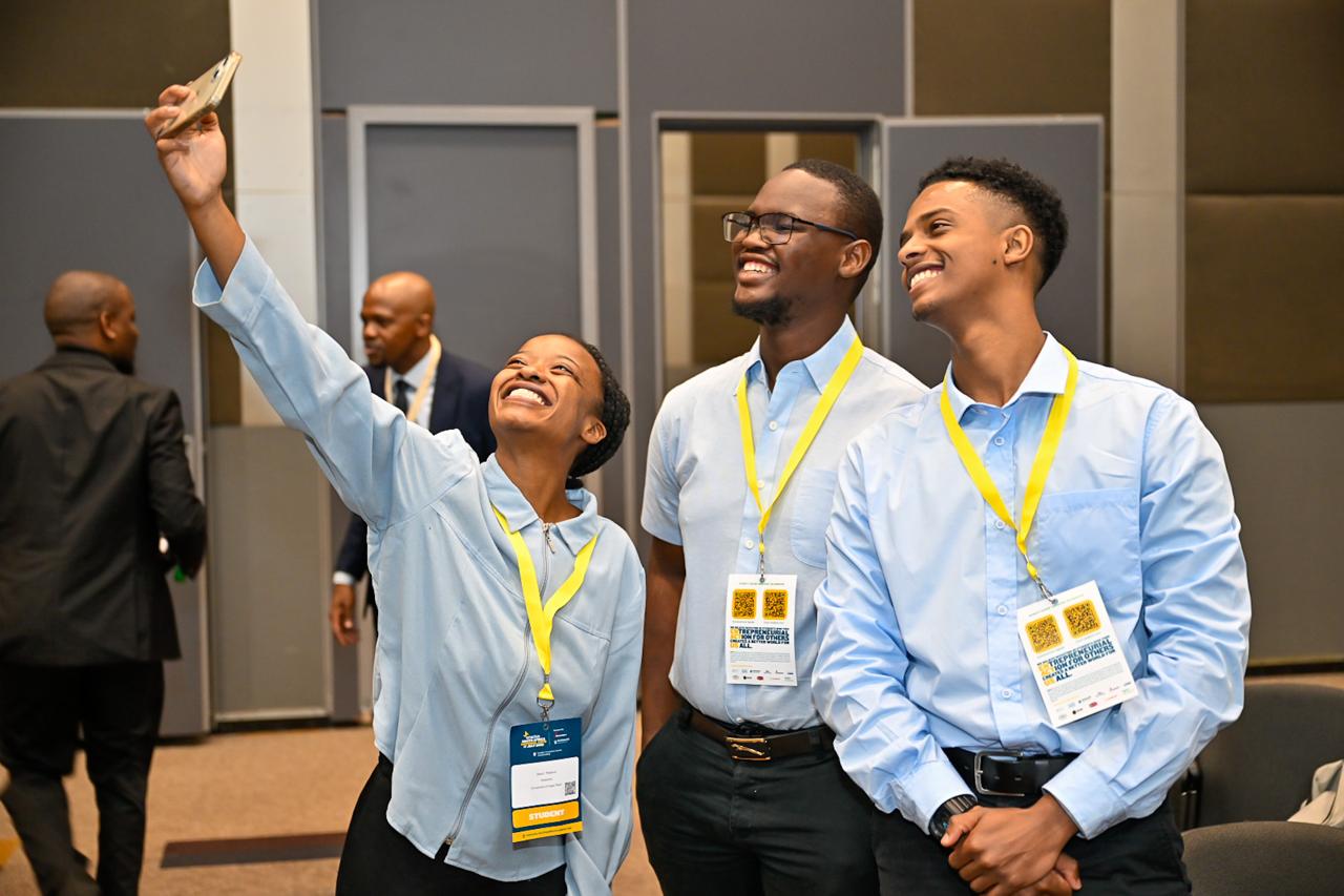 Three Enactus UCT students take a selfie at the Enactus South Africa Expo.