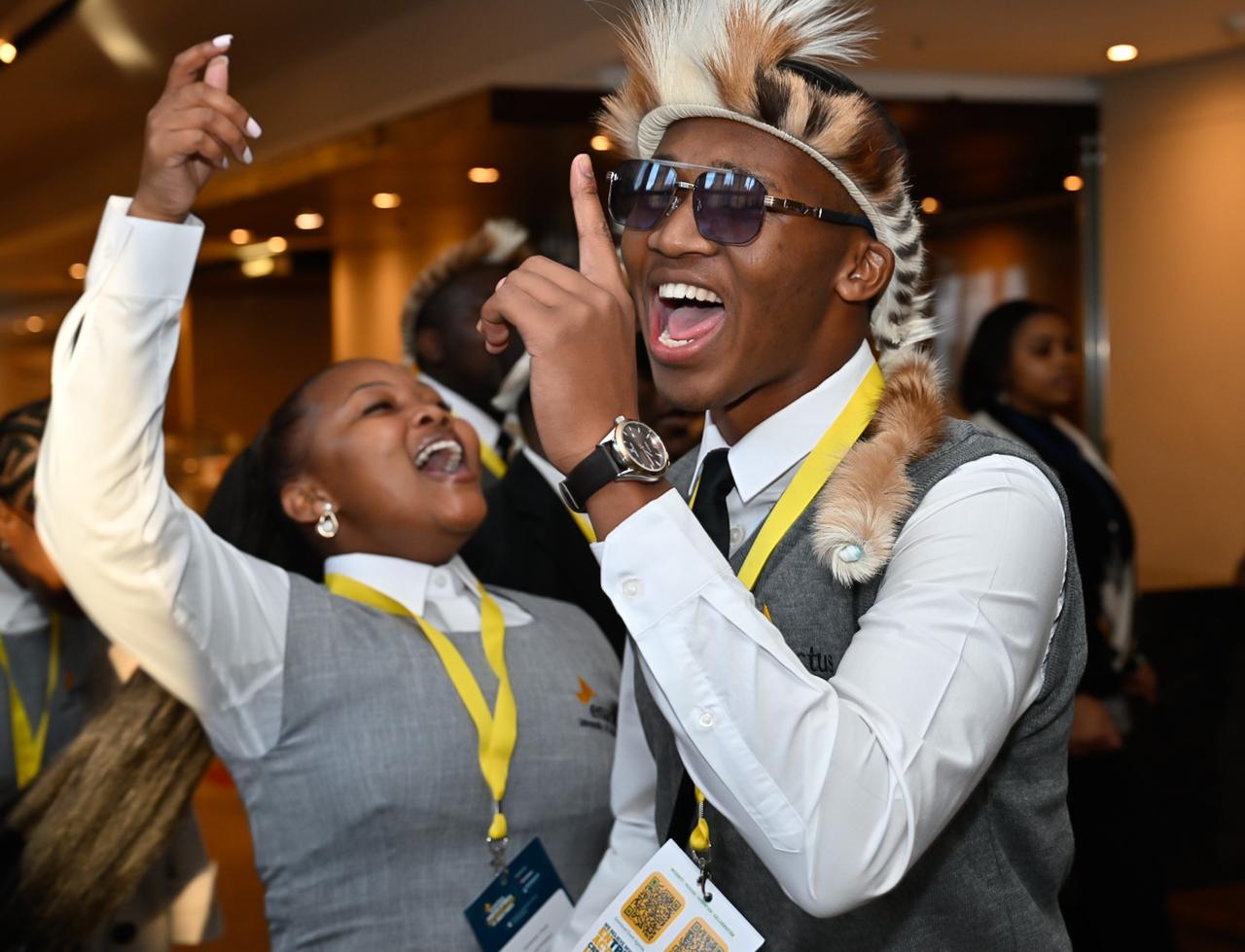 Two Enactus UKZN students celebrate in formal and traditional attire at the 2025 National Expo.