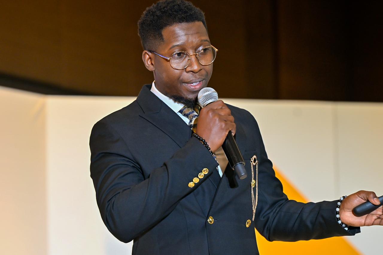 Enactus alumni, LuvoGugwana speaks on stage at the 2025 National Expo.